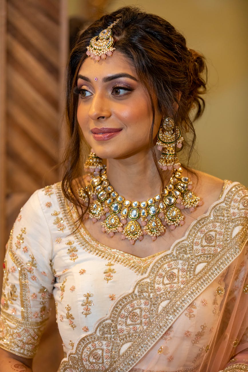 a beautiful indian bride wearing a gold and pink lehenga
