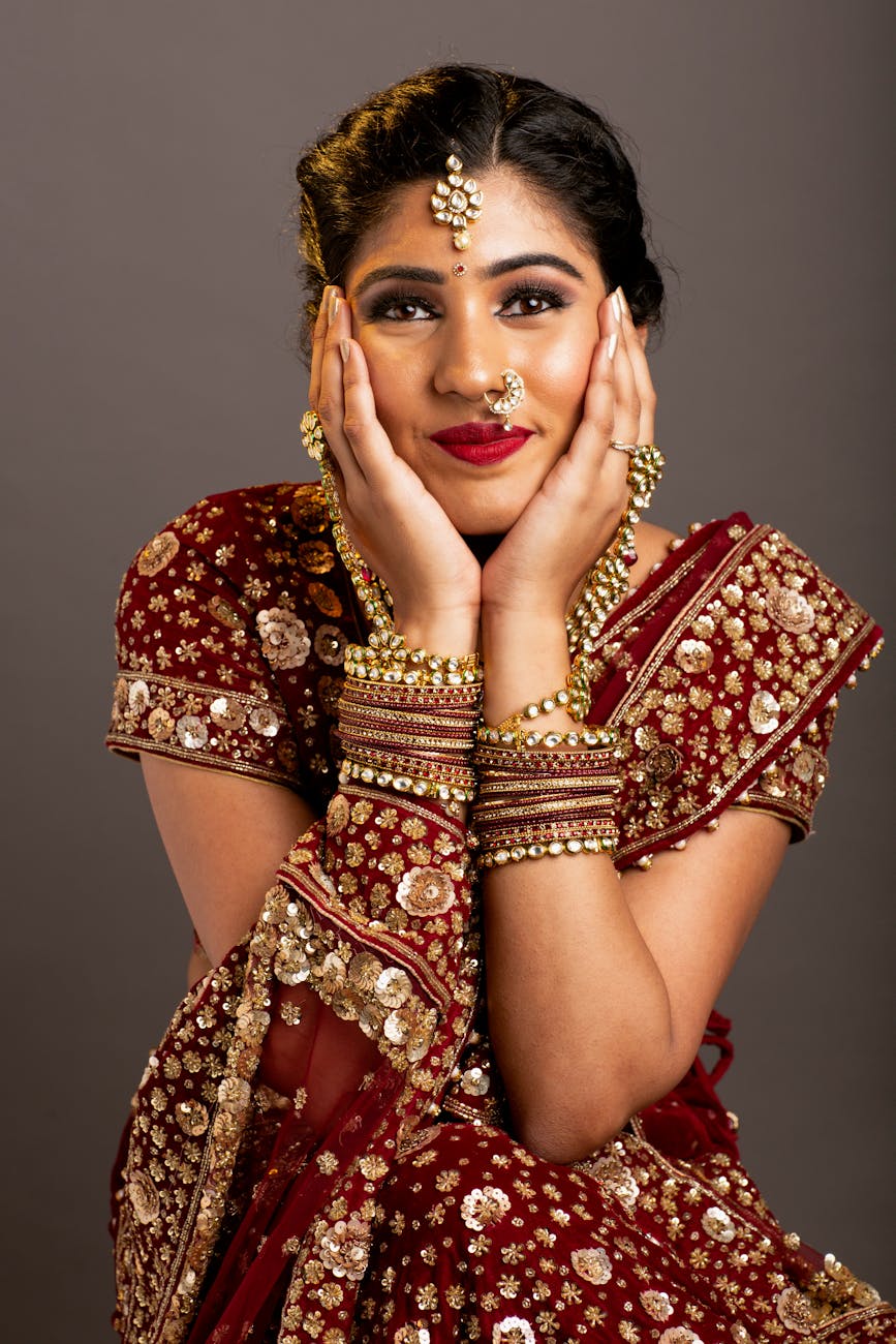 an elegant woman in a red saree posing