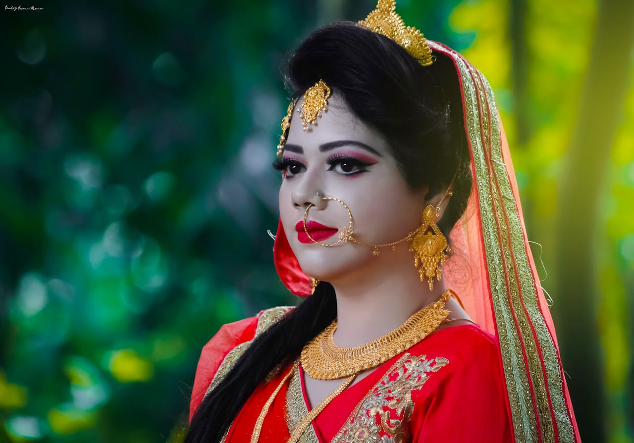 Elegant portrait of a woman wearing traditional bridal attire, featuring vibrant colors and exquisite jewelry.